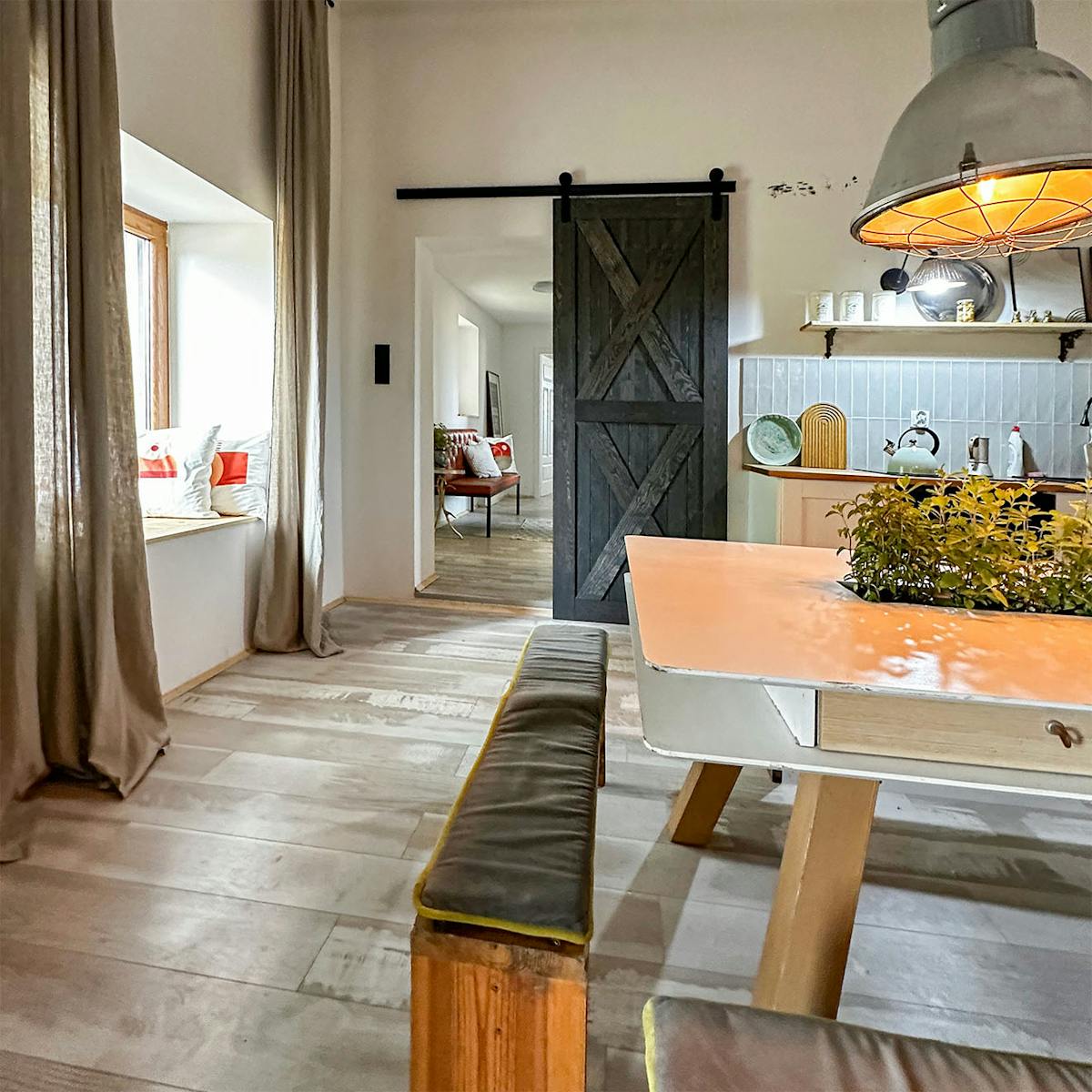 Schwarze Schiebetüren verbinden die Küche und das Esszimmer mit dem Flur