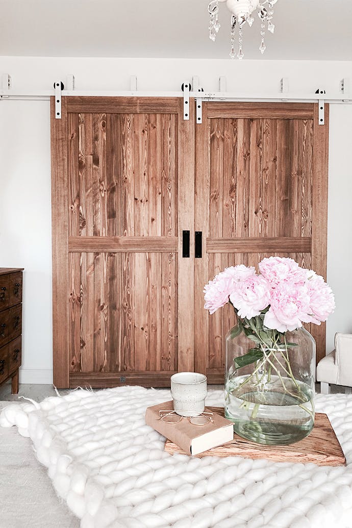 rustic bedroom, wooden sliding doors, bypass sliding doors, bypass wall bracket for sliding doors, rustic style interior, modern rustic style, barn sliding doors, white sliding system