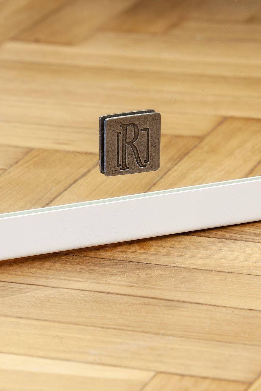 mirror in a white metal frame