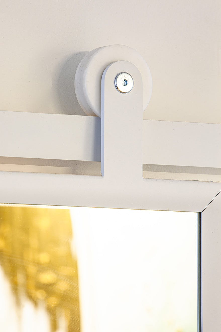 sliding door with a mirror in a white metal frame