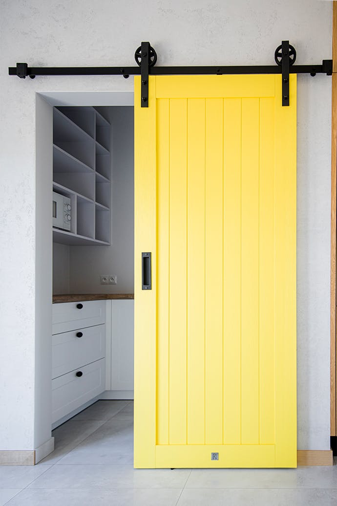 yellow sliding door, sliding pantry door, unique sliding system, yellow door, modern kitchen, pantry entrance, yellow wooden door