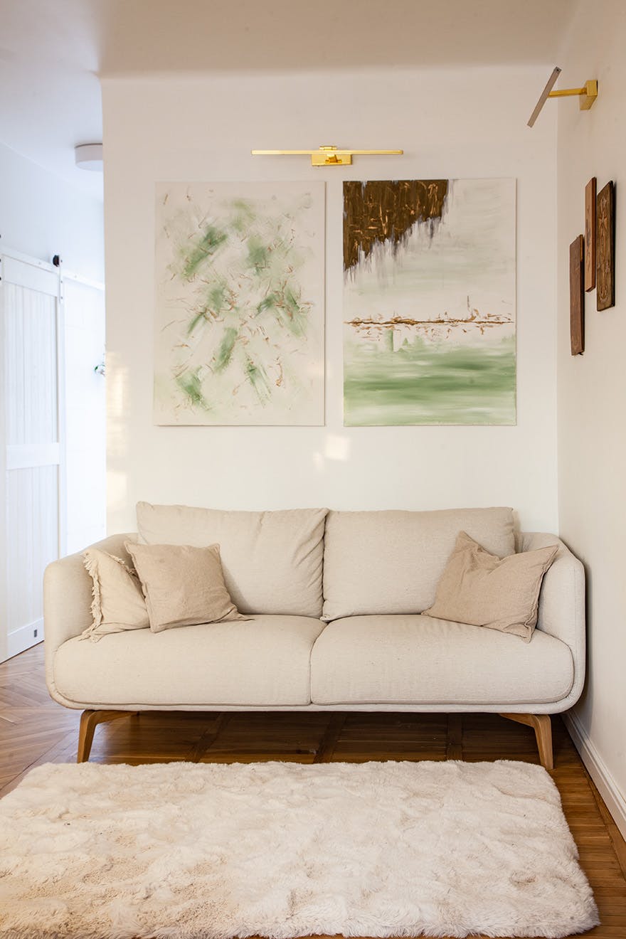 paintings hanging above a bright sofa in the living room
