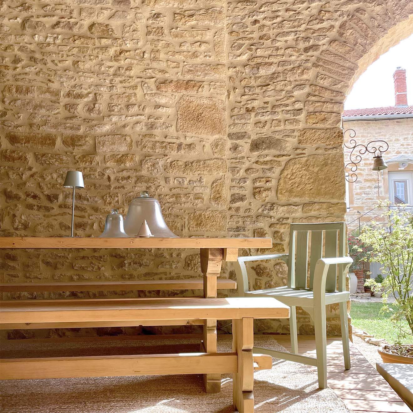 überdachte Terrasse umgeben von Natursteinmauern