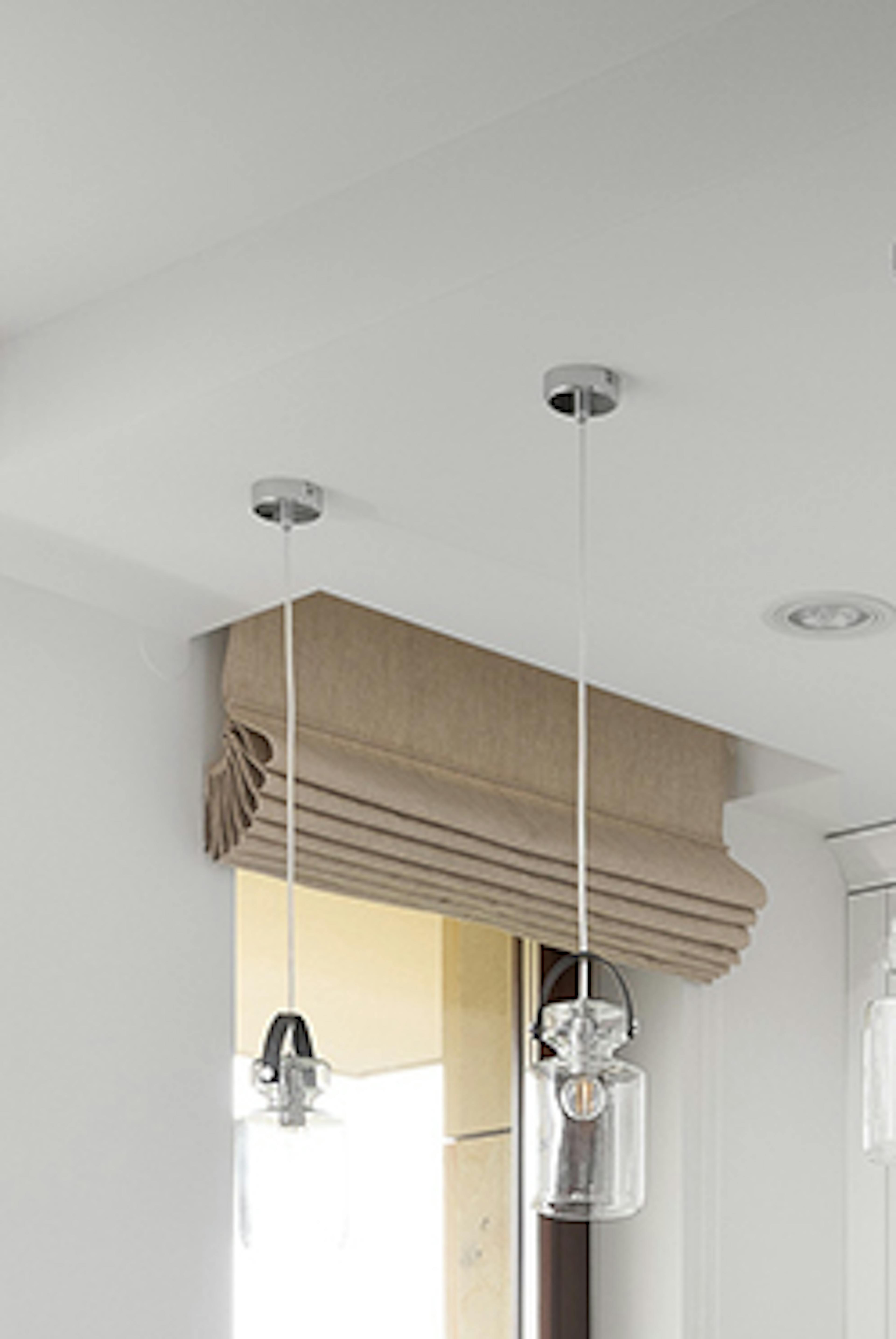 Une kitchenette décorée en blanc avec des accessoires en métal noir