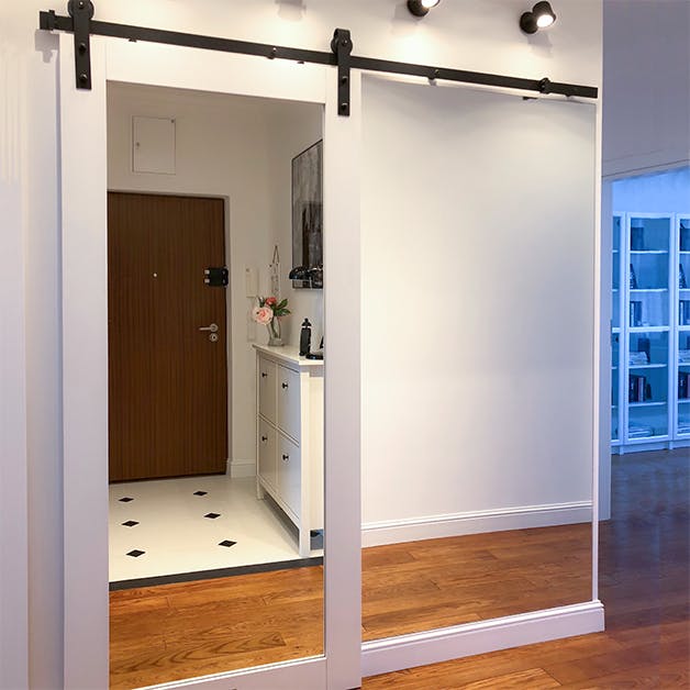 porte coulissante en bois blanc avec un grand miroir dans le hall