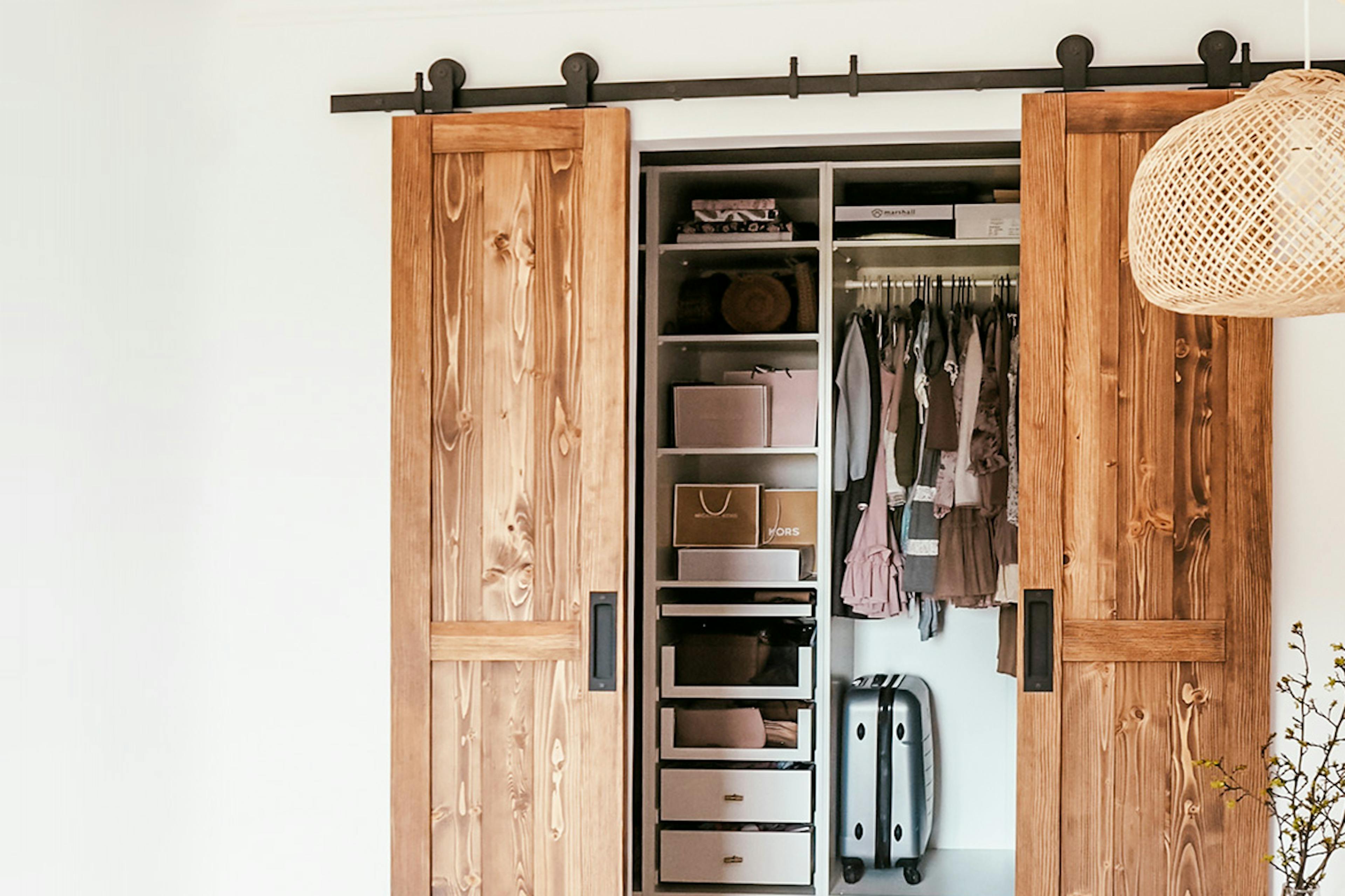 portes coulissantes étroites en bois à double battant fermant l'armoire dans une chambre naturelle