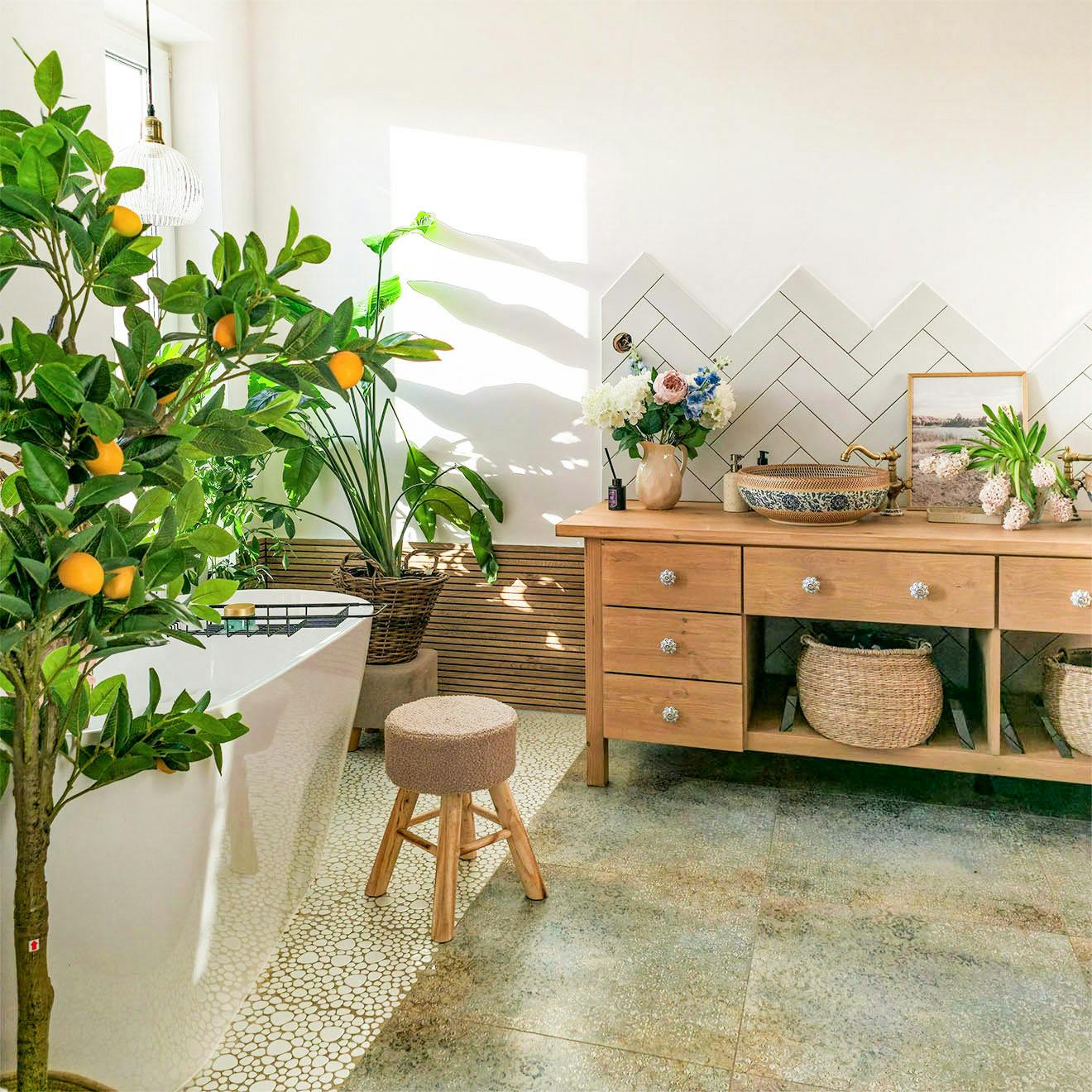 bathroom arrangement with a free-standing bathtub, wooden cabinet with countertop sinks