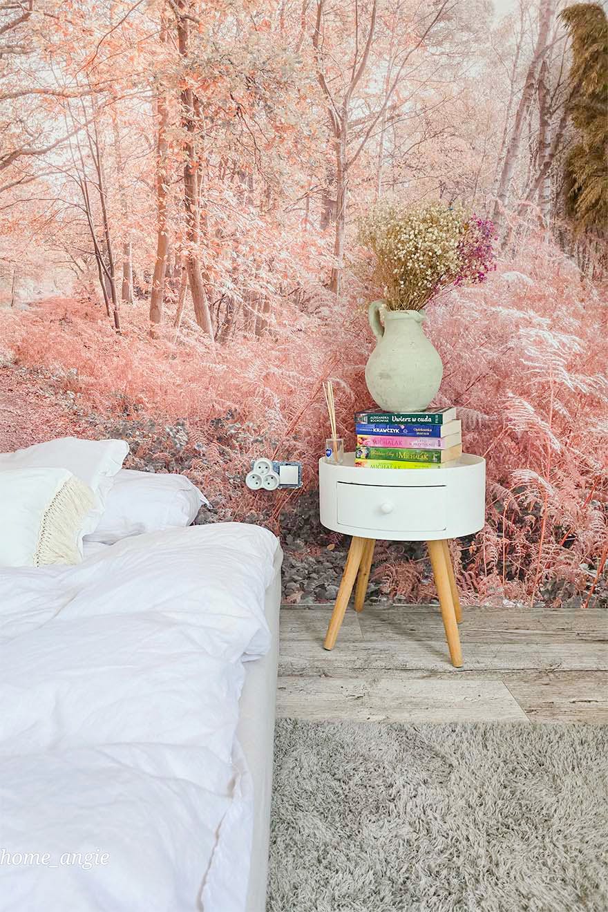 close-up of a forest-themed photo wallpaper and a nightstand in a bedroom
