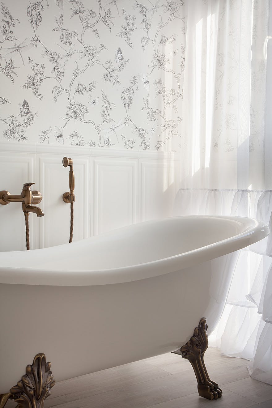freestanding bathtub on decorative legs in a Provencal style bathroom