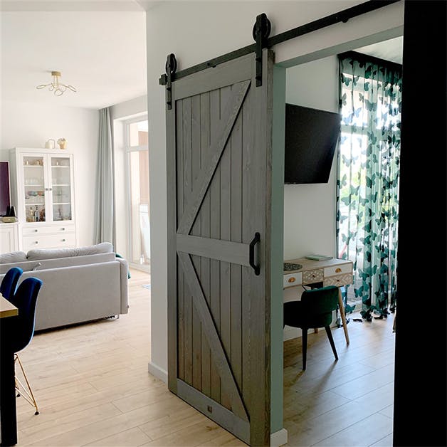 wooden sliding doors, barn sliding doors, grey wood sliding door, golden interior accessories, modern interior, bedroom entrance, grey tones in the interior, bedroom sliding door, dressing table in Scandinavian style