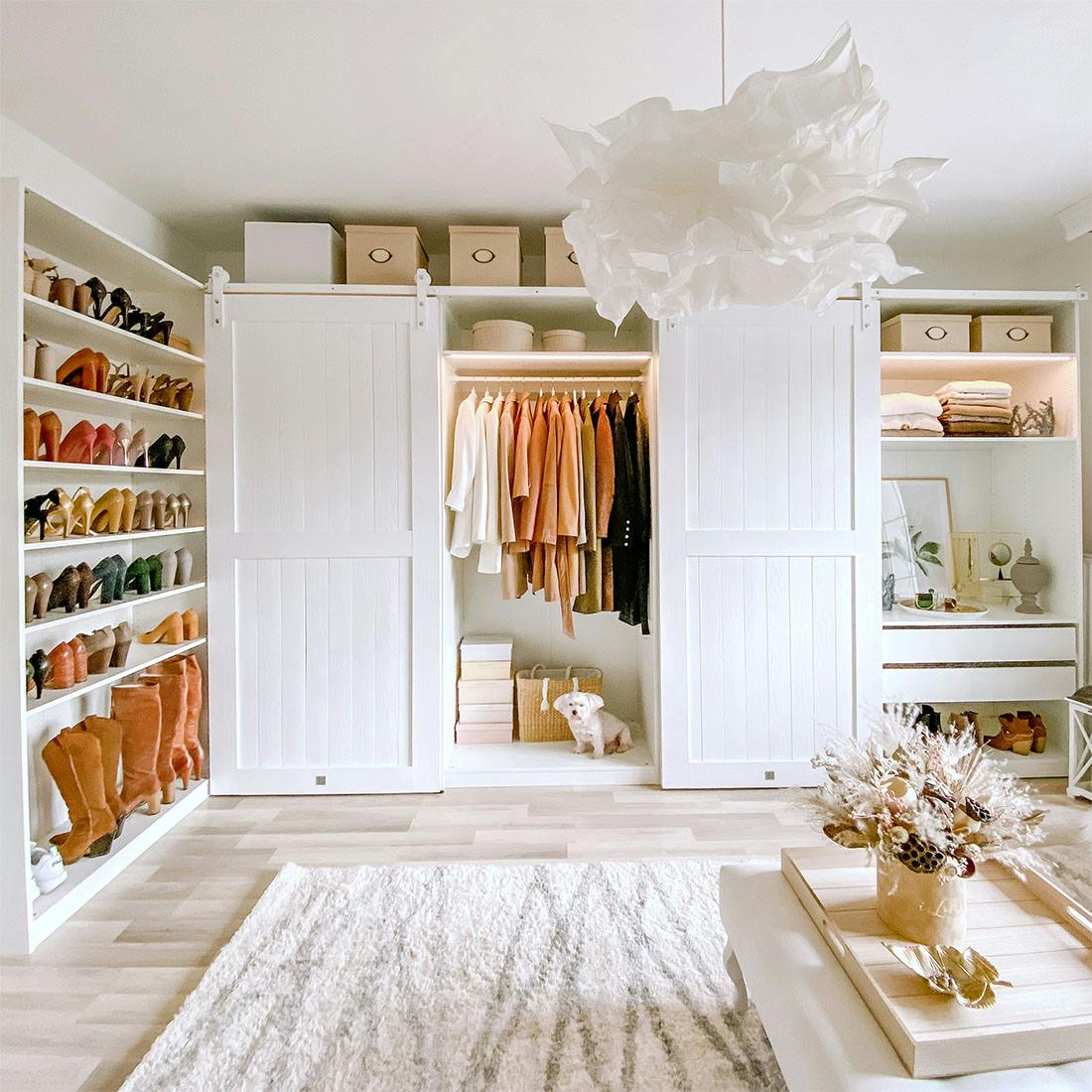 large bright walk-in closet, sliding doors in walk-in closet, large white wooden doors, white doors on white sliding system, large white closets in dressing room