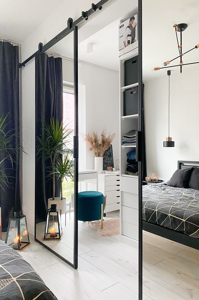 Portes coulissantes doubles avec miroir comme entrée d'une armoire décorée dans des tons blancs