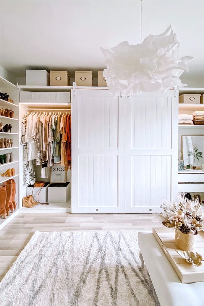 pendant lamp paper lampshade, white sliding doors for the wardrobe, barn door in the walk-in closet, a system of white wardrobes and shelves in the dressing room, large wardrobe in white, white doors on a white sliding system
