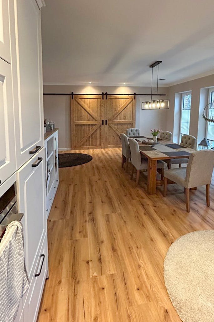 open kitchen with dining area and double sliding doors