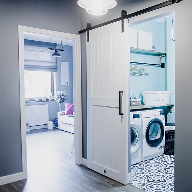 white sliding door, sliding door system, modern farmhouse style, laundry door, hallway sliding door, gray colors, black decorative elements, mosaic on the floor