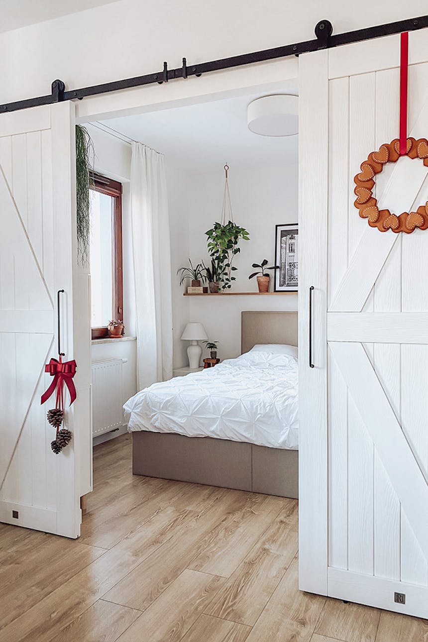 Doppel-Schiebetür aus weißem Massivholz, Schiebetür für Schlafzimmer in Weiß, großes Bett mit gepolstertem Kopfteil