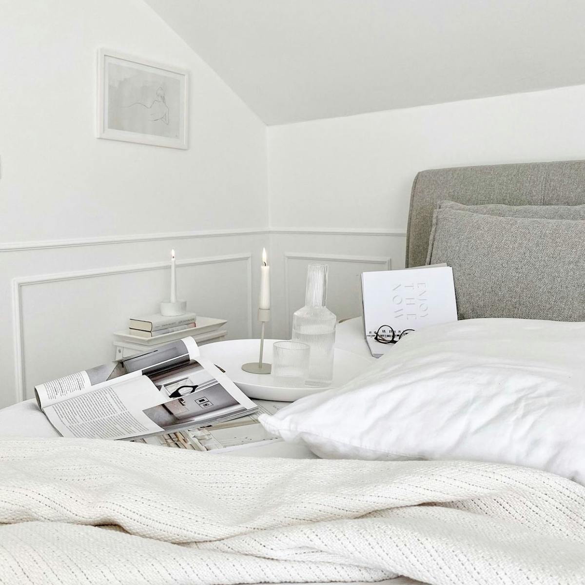 biała pościel na łóżku z tapicerowanym zagłówkiem